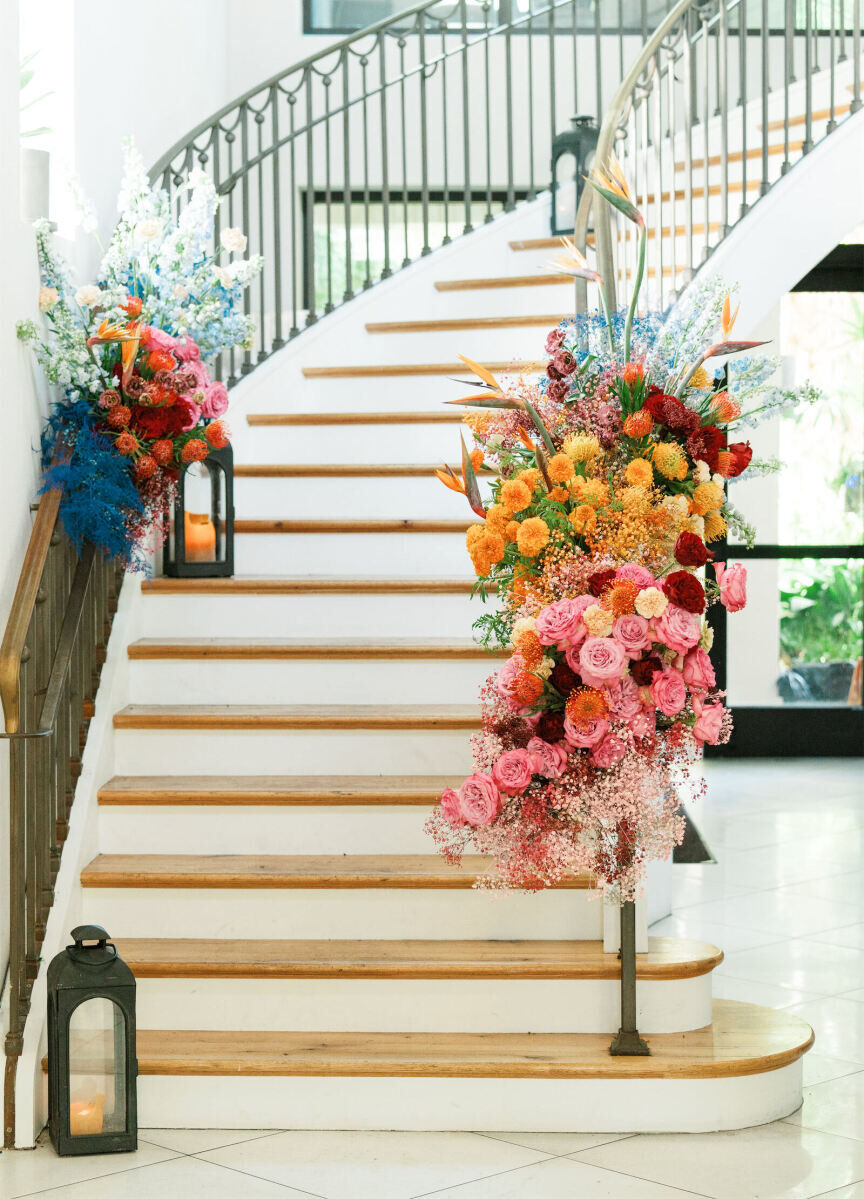 Flowers at an art-inspired wedding were arranged in colorful bursts along a staircase.