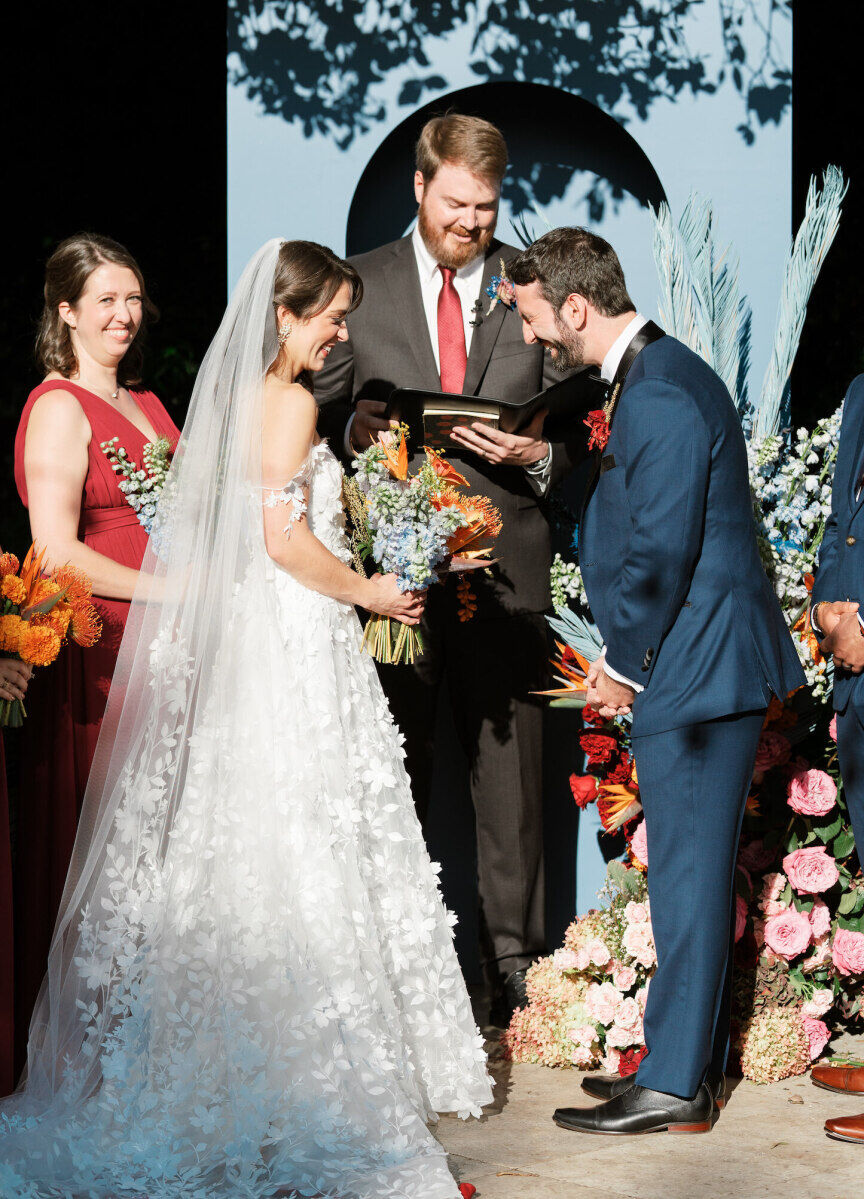 A bride and groom share a laugh during their art-inspired wedding ceremony at Cannon Green in Charleston, South Carolina.