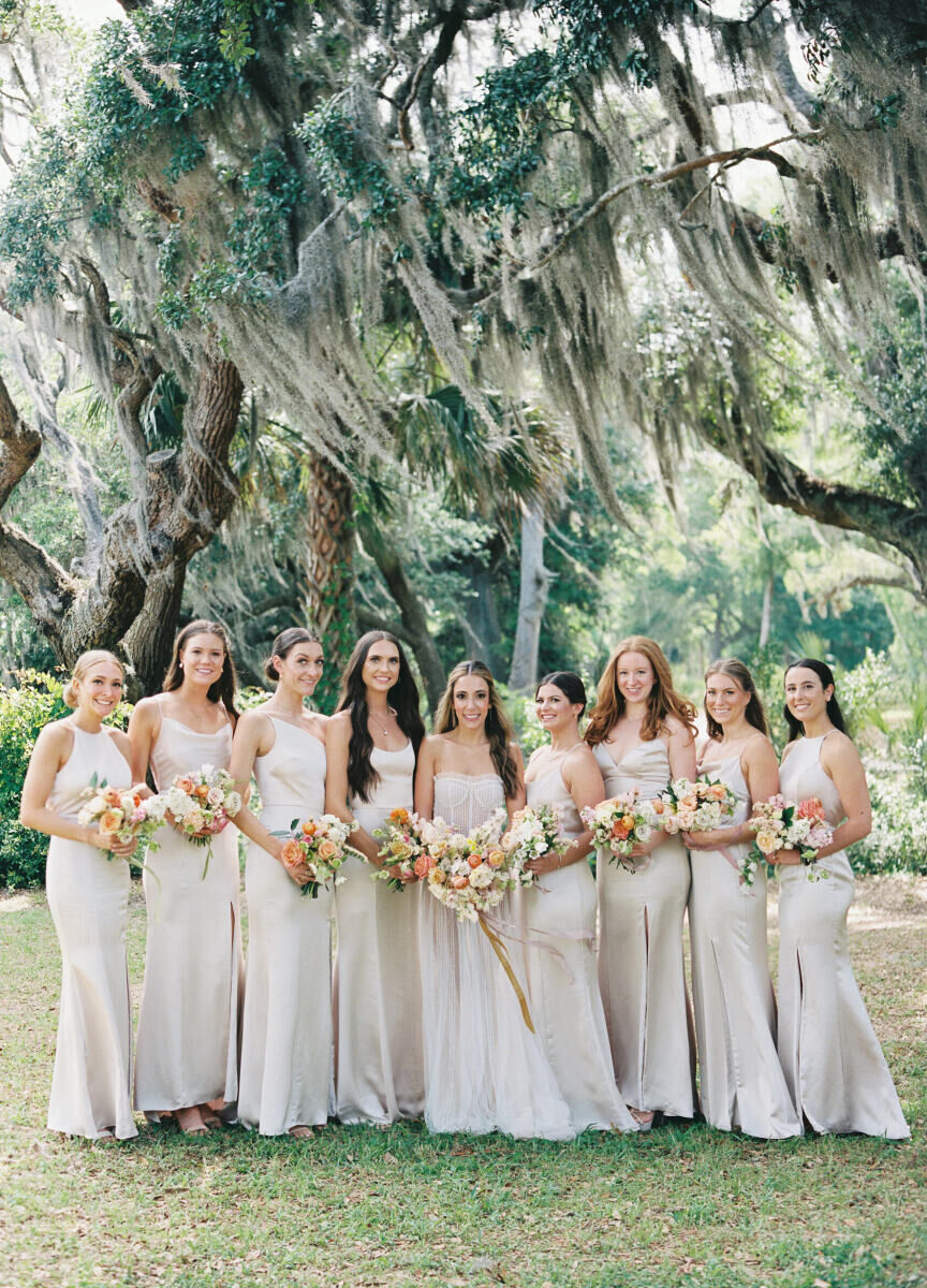 A bride and her bridesmaids wore a mix of hair styles and held pastel bouquets at this elegant spring wedding.
