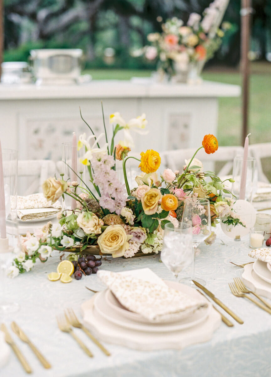 An elegant spring wedding incorporated a color palette of bright yellows and oranges, which popped against soft green table linens.