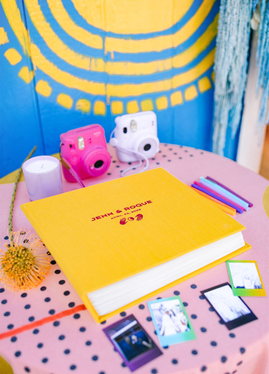 With the bride being a professional photographer, it was fitting to have a guest book that prompted guests to snap instant pics to tuck inside. The frames of the photos and the book they went into were of course colorful, and befitting this vibrant, outdoor wedding.